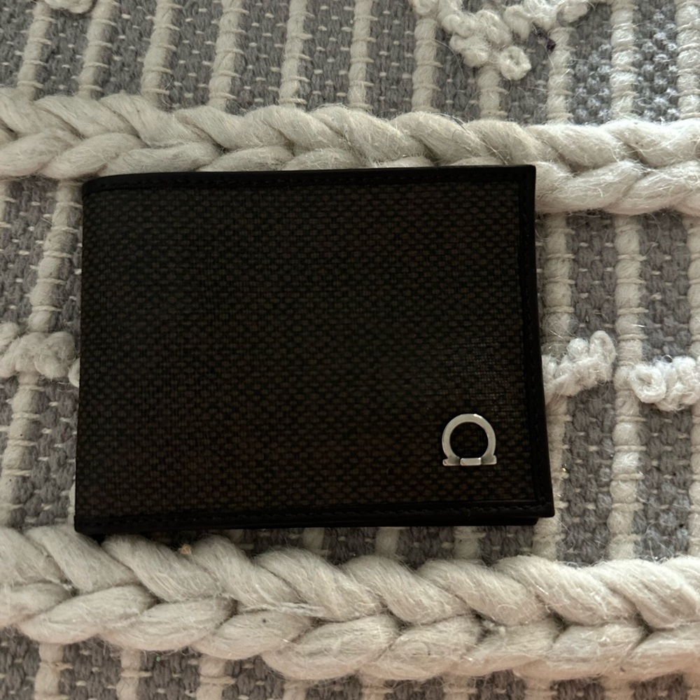Dark brown never used Ferragamo wallet for men.